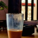 A steaming cup of strong milk tea.